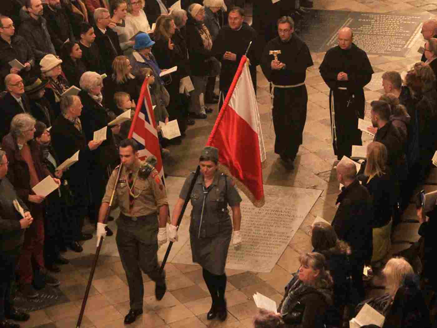 The flags of the United Kingdom and Poland are borne through the Abbey