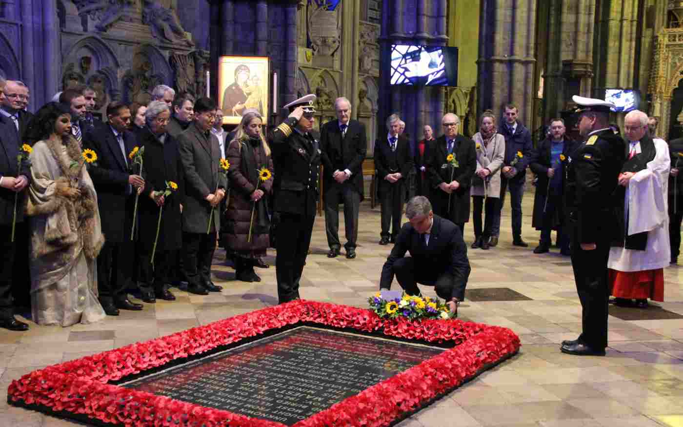 The Ukranian Ambassador laying a wreath at the Grave of the Unknown Warrior. Other members of the congregation stand and watch