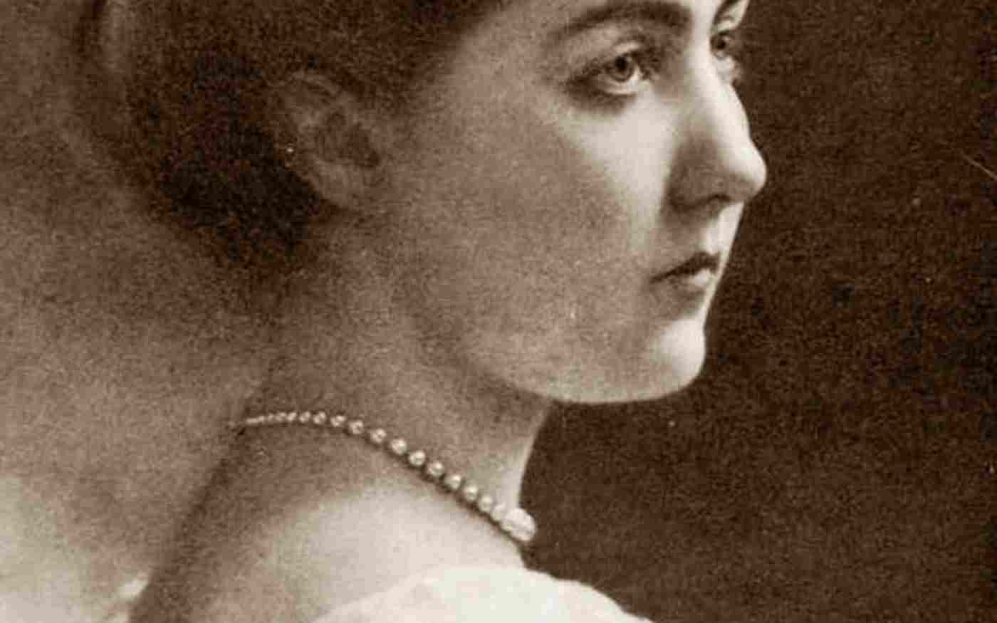 Princess Patricia of Connaught photographed side-on wearing a white dress and pearl necklace
