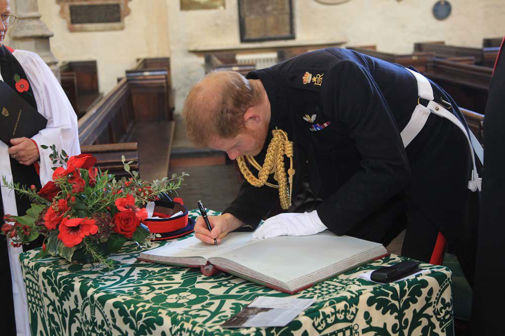 The Duke of Sussex signs the Distinguished Visitors' Book in St Margaret's Church