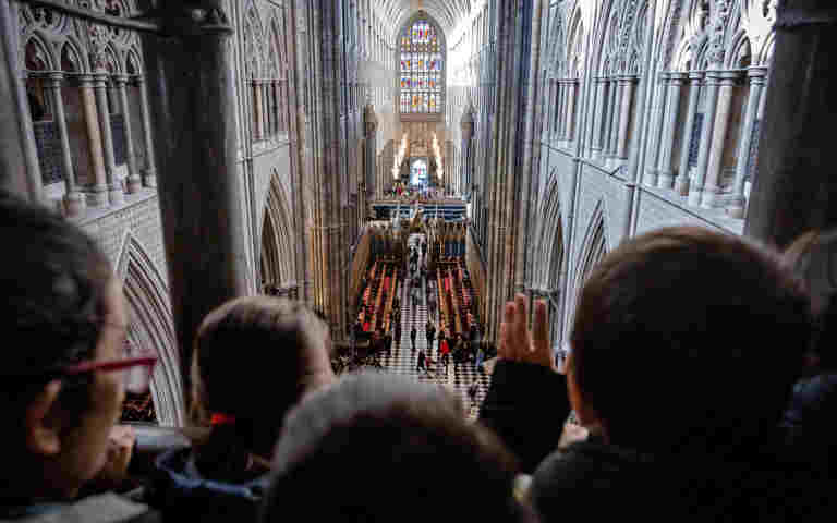 Photograph of the backs of children's heads looking at the view to Westminster Abbey