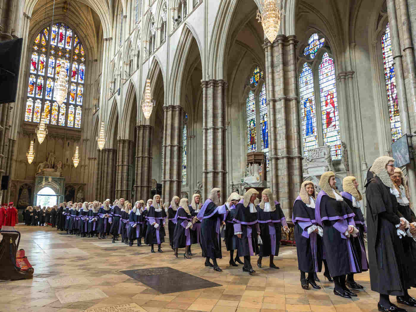 Judges wearing black robes and purple robes being processed through the Abbey