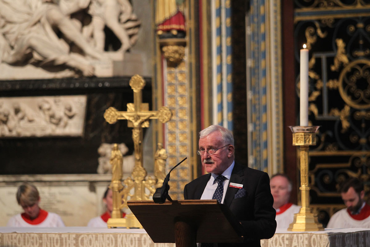 Phil Lyons MBE, Chief Executive of the National Holocaust Centre and Museum, reads from the Nave Lectern