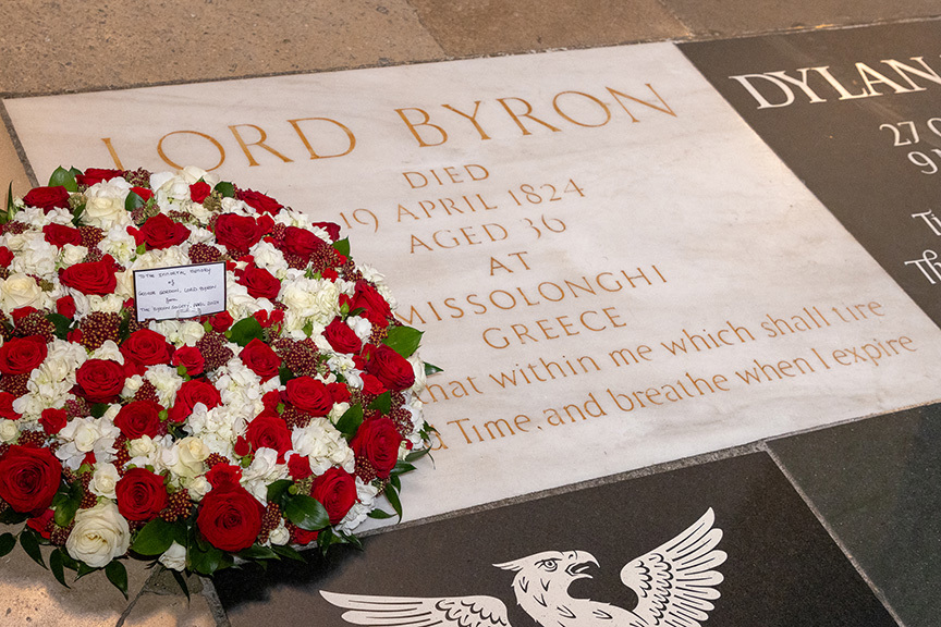 Lord Byron memorial with floral wreath of red and white roses