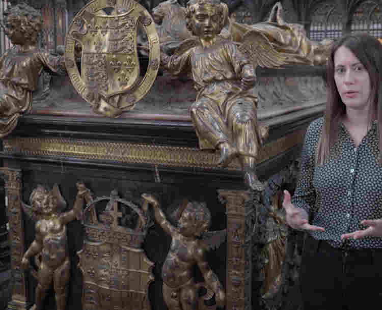 Photograph of female Learning Officer talking and gesturing next to the tomb of Henry VII and Elizabeth of York in the Lady Chapel of Westminster Abbey