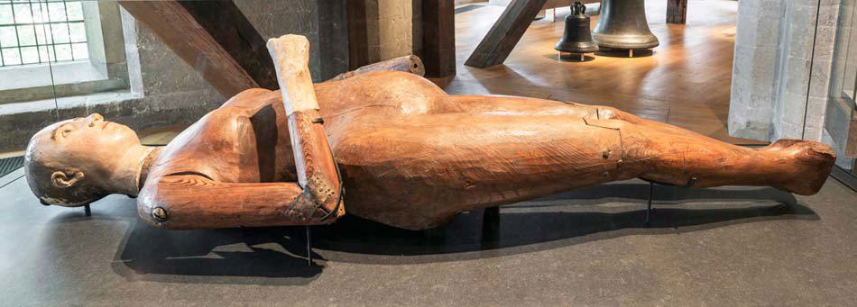 Wooden funeral effigy of Mary I, lying on a flat surface, left hand missing in Abbey Galleries Museum