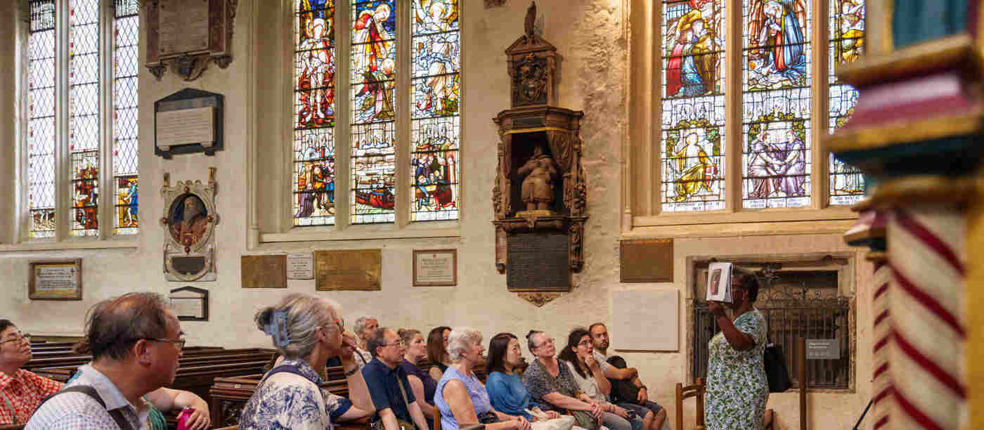 Photograph of members of the public listening to a speaker in St Margaret's Church at Westminster Abbey