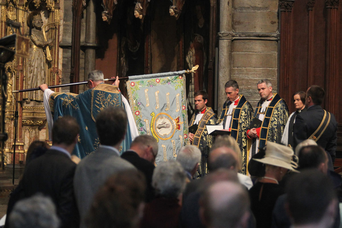 The Standard of Number 17 Squadron is laid by the Dean upon the High Altar