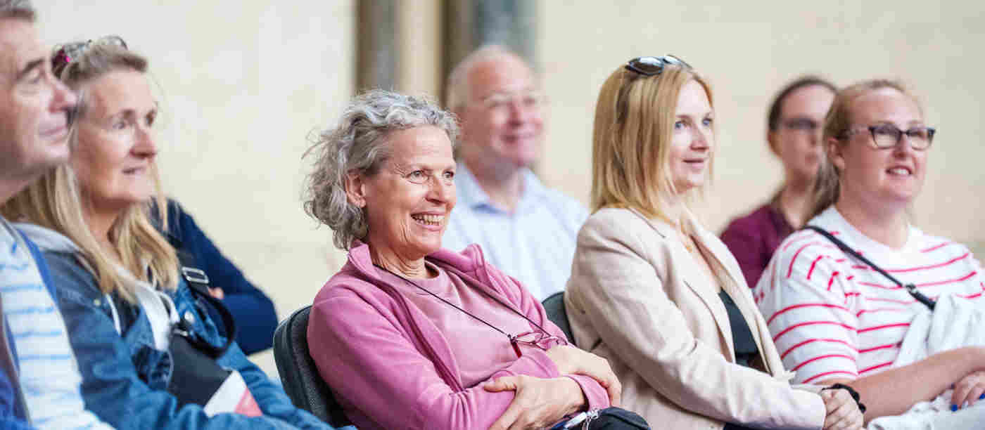 Photograph of seated members of the public listening to a talk within Westminster Abbey