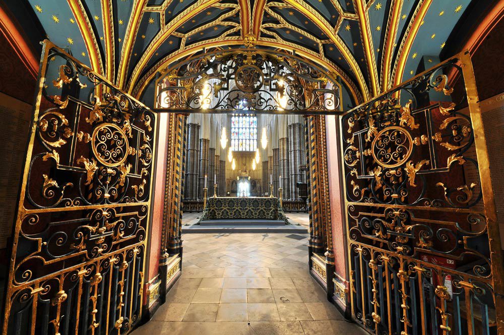 A view through the Quire Screen's gold-painted iron gates to an altar in the Nave of Westminster Abbey