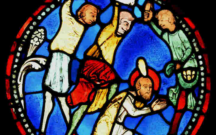 Close-up photograph of a section of stained-glass window showing the stoning of St Stephen within the Queen's Diamond Jubilee Galleries within Westminster Abbey