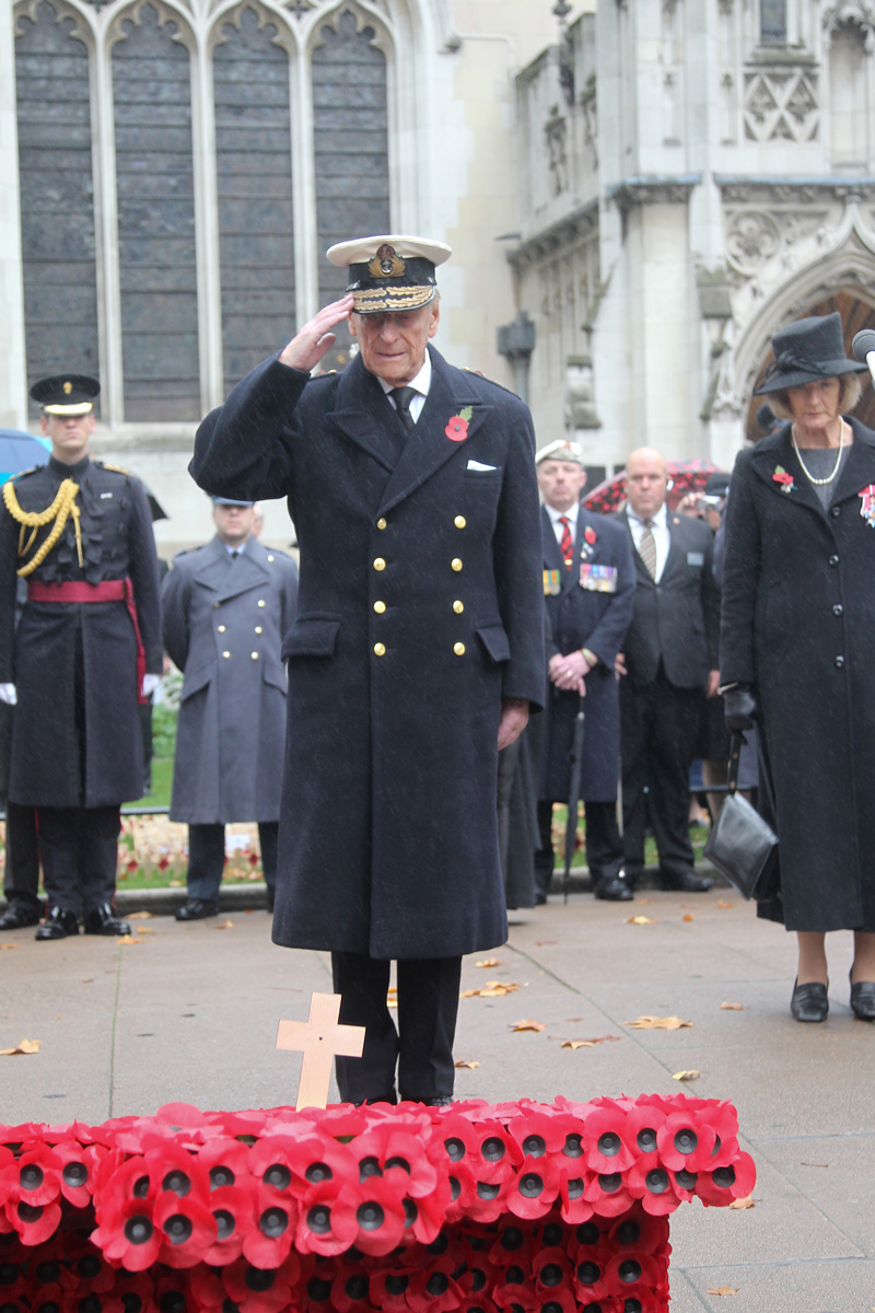The Duke of Edinburgh and Prince Harry laid crosses of remembrance in front of two wooden crosses from the Grave of Unknown British Soldiers from the First and Second World Wars