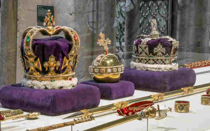 Photograph of the replica royal regalia, including two crowns, an orb and sceptres displayed in the Queen's Diamond Jubilee Galleries at Westminster Abbey
