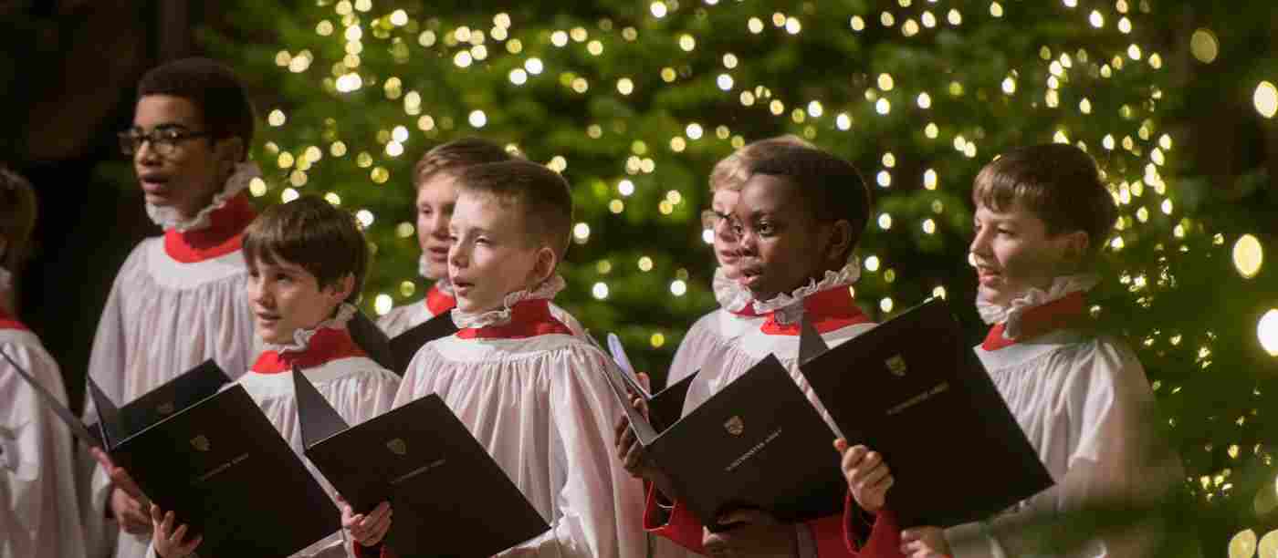 The Choir singing in front of a Christmas tree