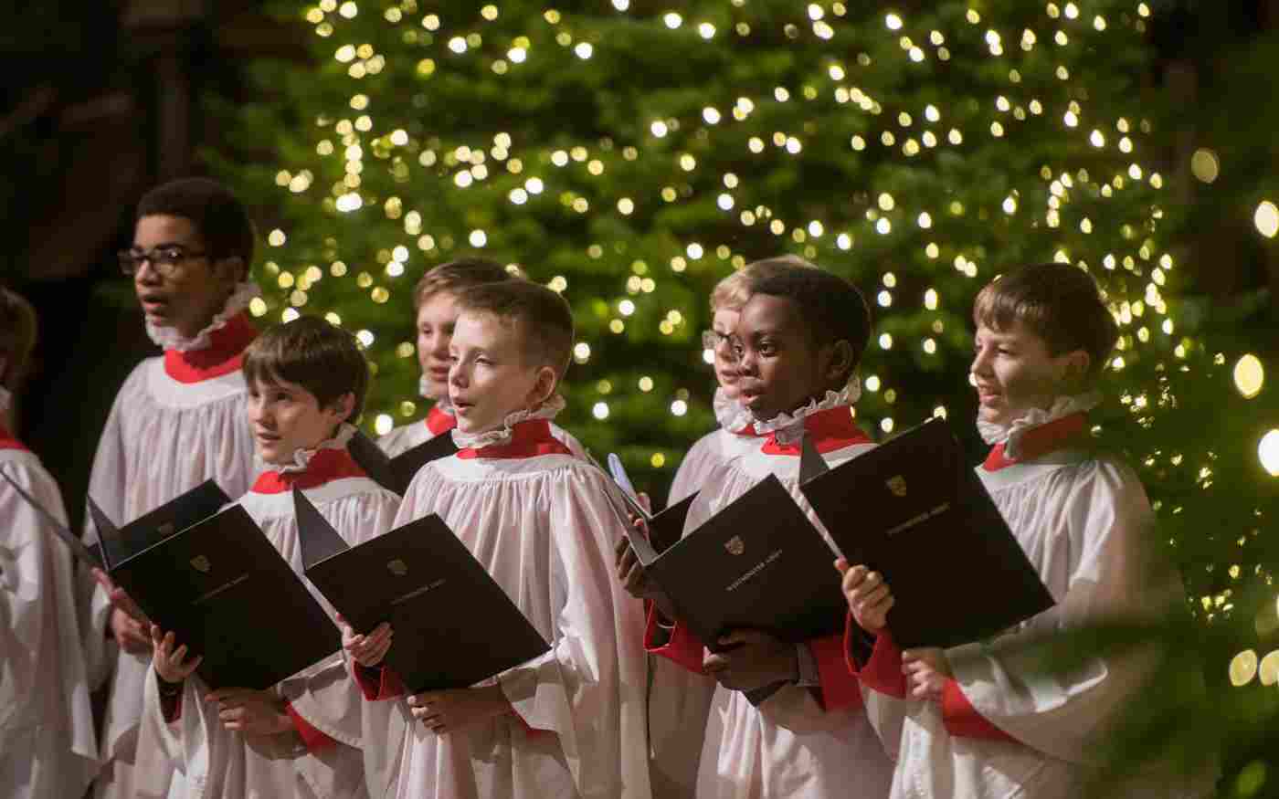 The Choir singing in front of a Christmas tree