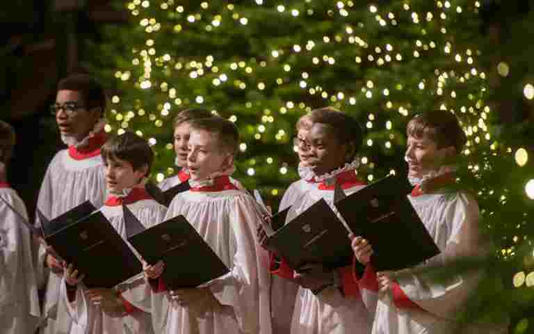 The Choir singing in front of a Christmas tree