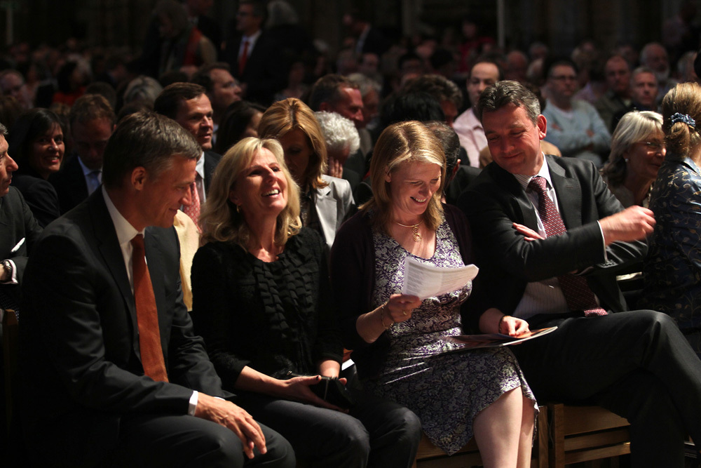 Audience members share a joke prior to a lecture in the nave of Westminster Abbey