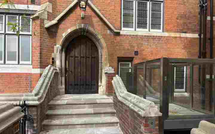 Photograph of the door to a building, with an outdoor lift, at Westminster Abbey