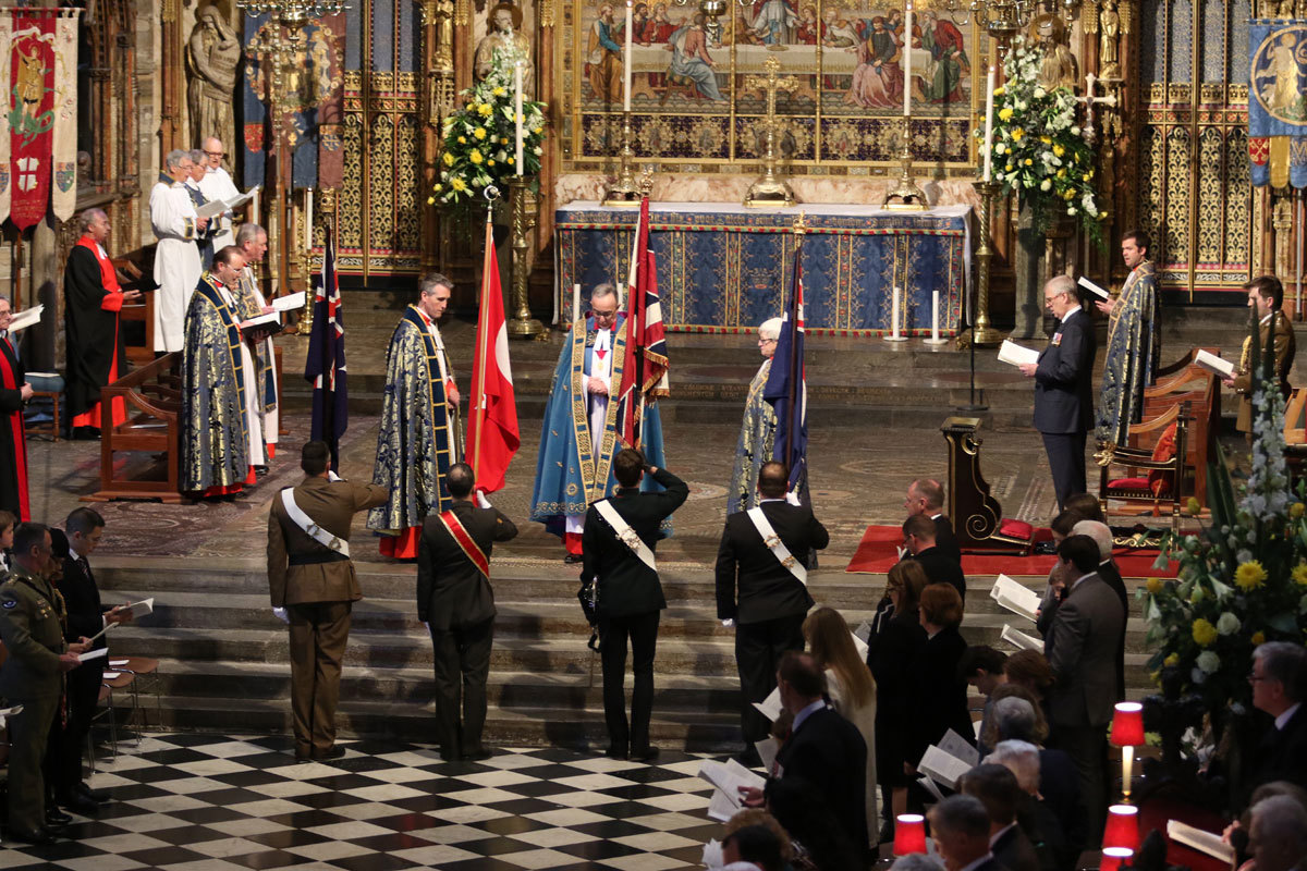 The Dean of Westminster, the very Reverend Dr John Hall, receives the flags