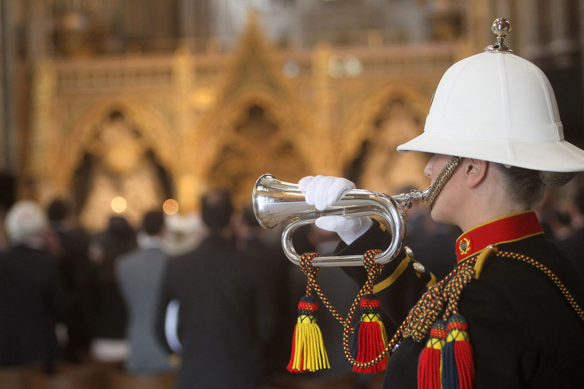 A trumpeter from the Royal Marine plays Reveille