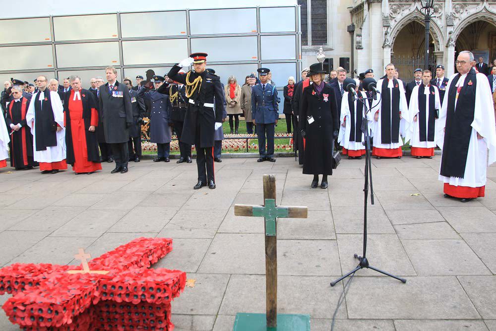 The Duke of Sussex salutes the memorial cross that he has just planted