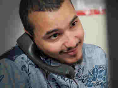 Photograph of male employee smiling while on the phone within a Westminster Abbey office