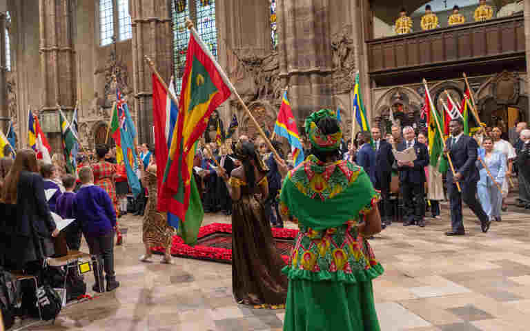Photograph of flags being processed within Westminster Abbey at a Commonwealth service