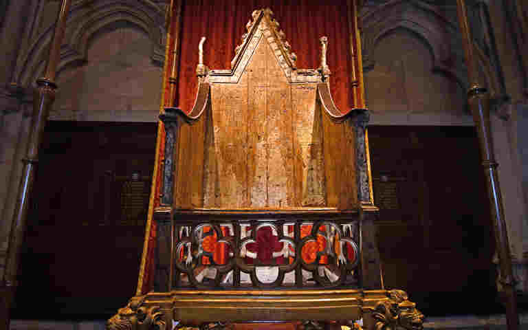The Coronation Chair. A large and worn chair )approximately 700 years old with a triangular top