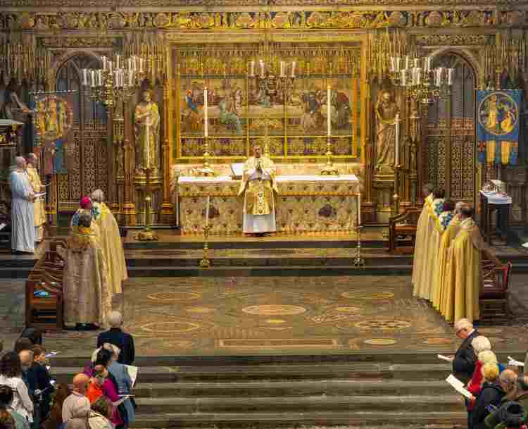 Photograph of members of clergy standing by the High Altar during a service in Westminster Abbey