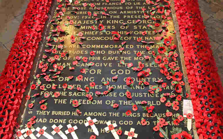 Photograph of the Grave of the Unknown Warrior, surrounded and covered with red poppies as well as woodden crosses, representing Remembrance as part of the Remembrance Live school event