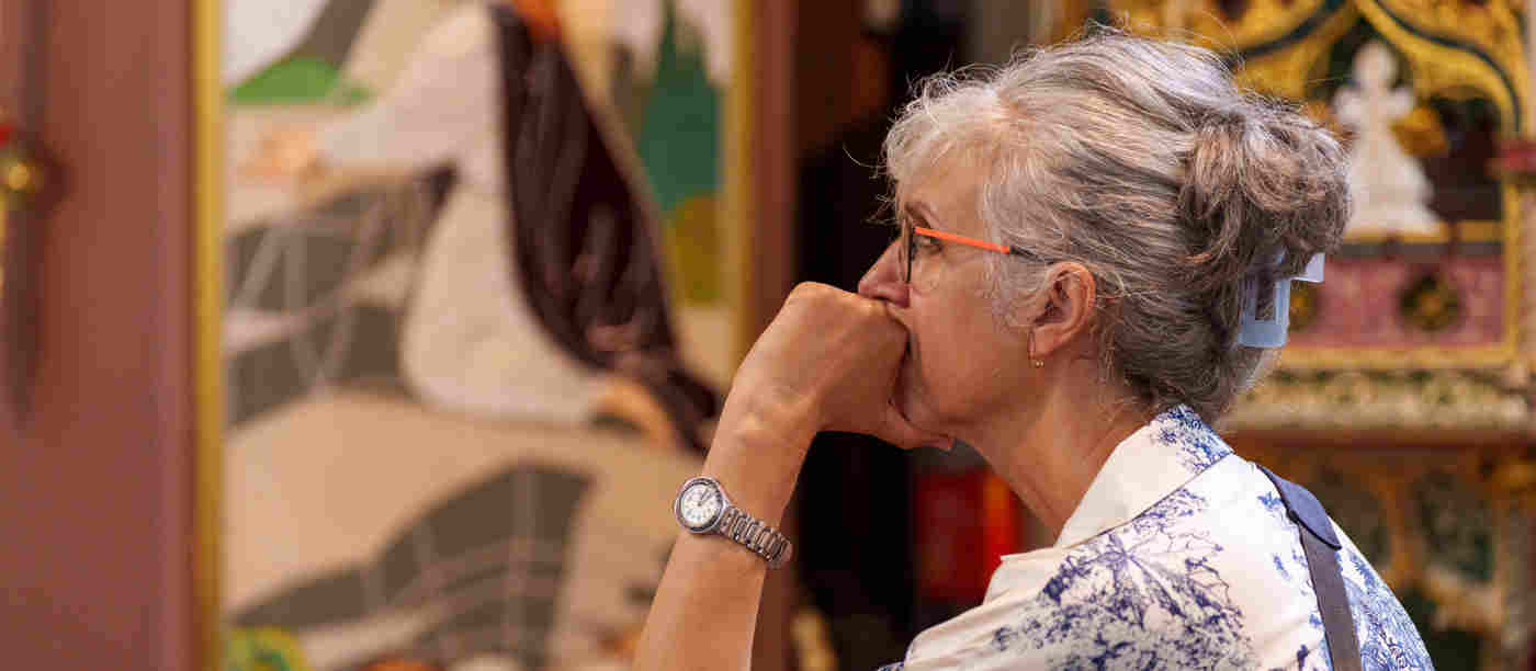 Photograph of one member of the public intently listening with the backdrop of St Margaret's Church