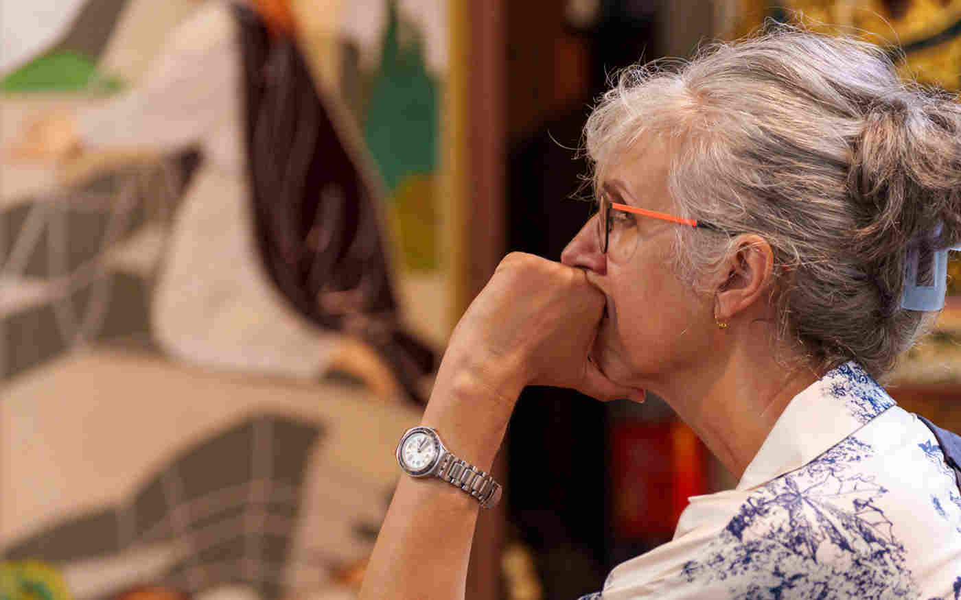 Photograph of one member of the public intently listening with the backdrop of St Margaret's Church