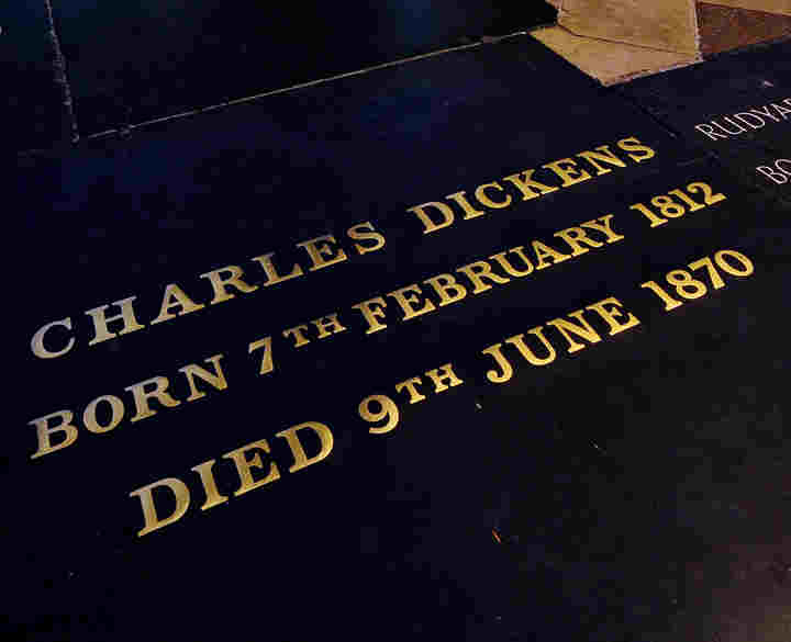 Photograph looking down at the grave of Charles Dickens with the inscription: Charles Dickens, born 7th February 1812, died 9th June 1870