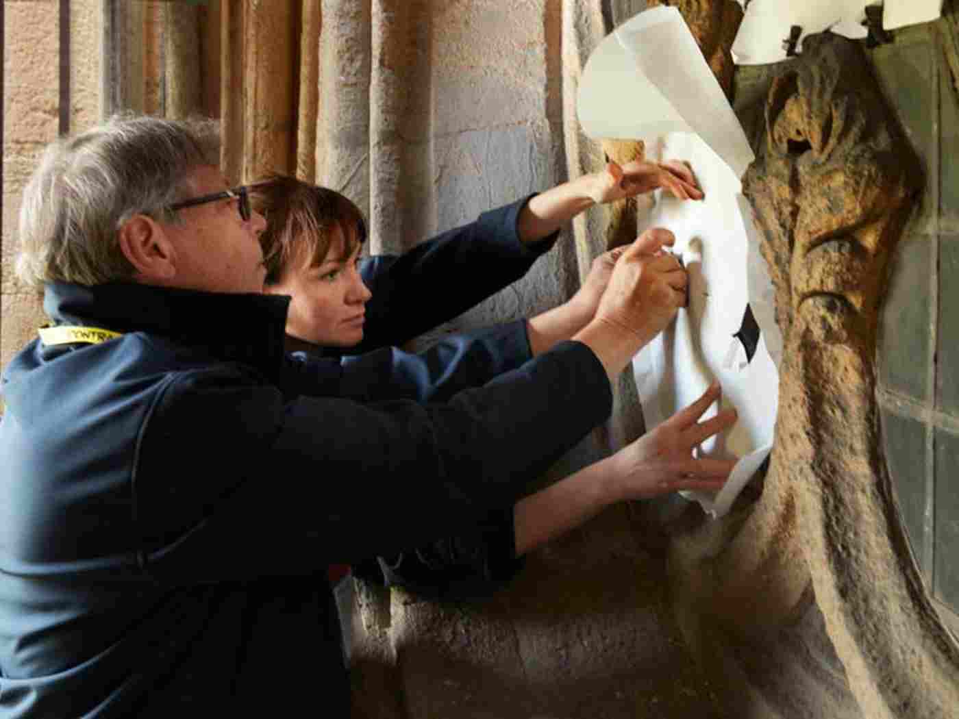 Keith Barley and Helen Whittaker take measurements and create stencils as part of the preparations for creating The Queen's Window, May 2017