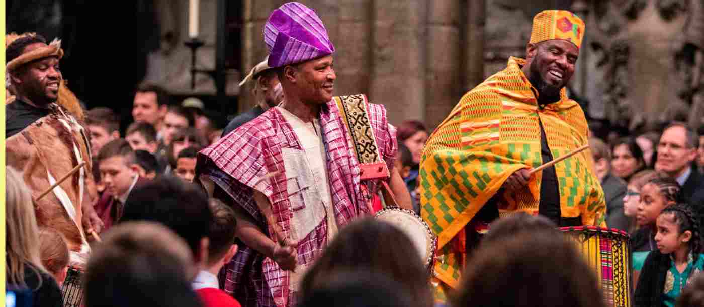 Two men playing drums down the Abbey Nave.