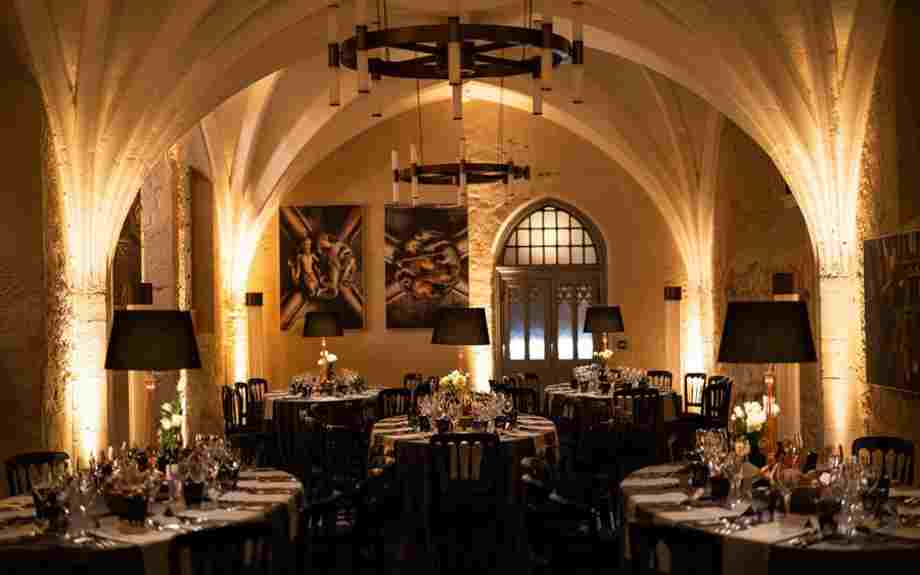 The Cellarium, Westminster Abbey, set with five round tables for a formal dinner