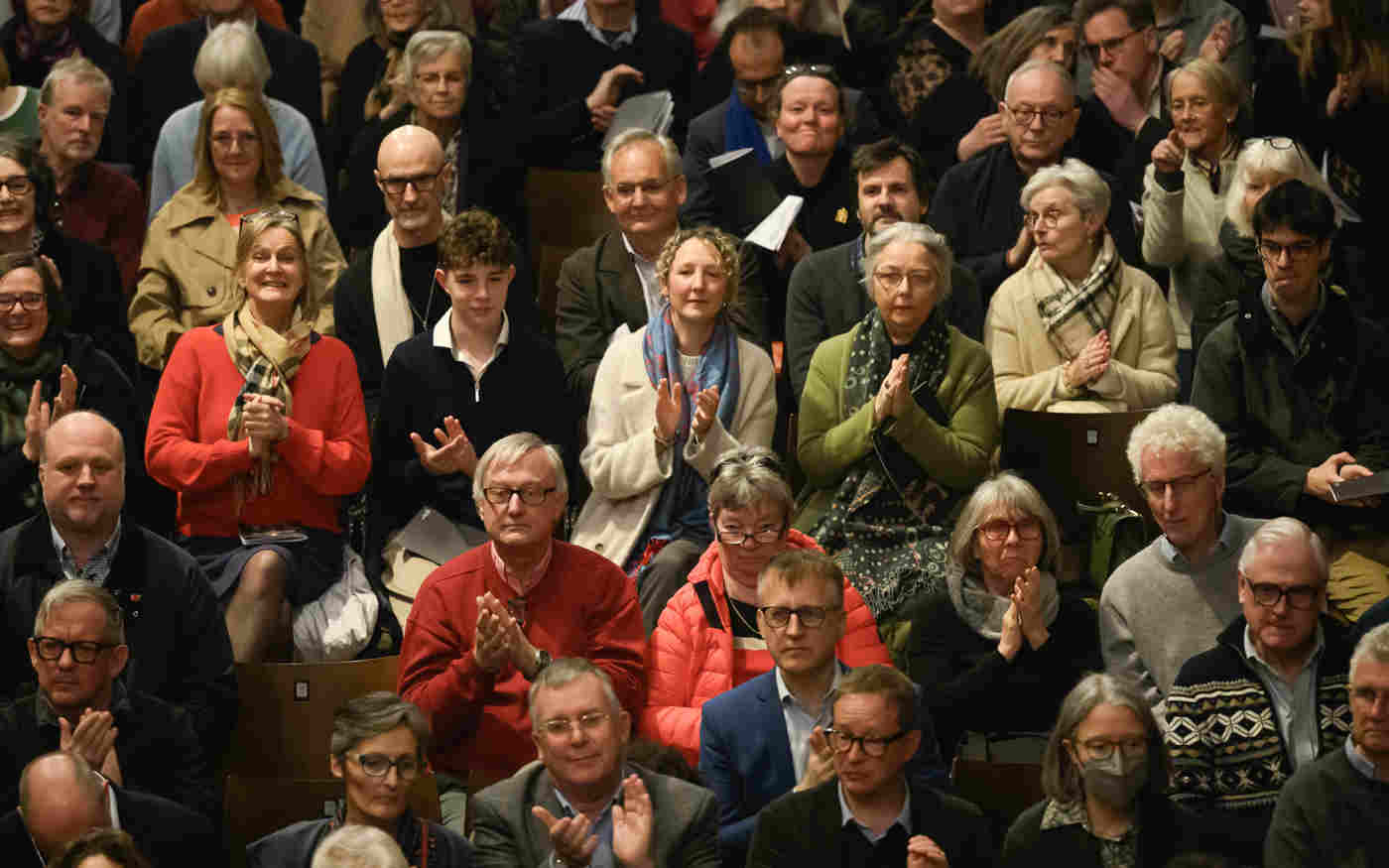 A front-facing photograph of a whole crowd of visitors listening to a talk