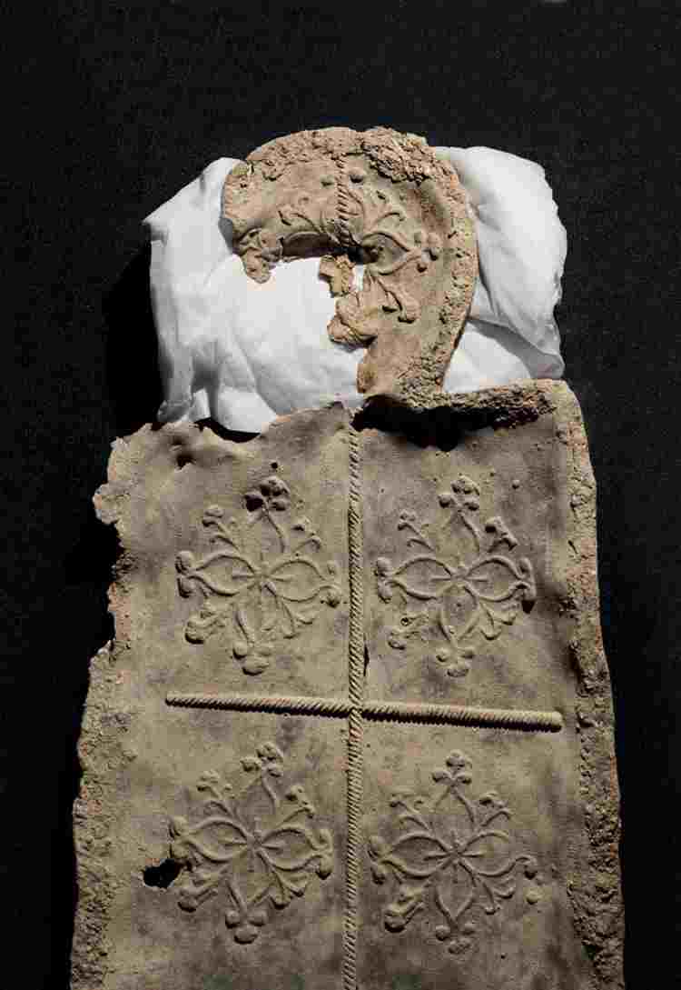 A shaped decorated lead coffin lid