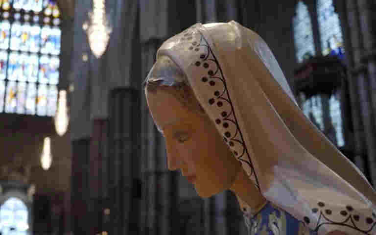 Photograph of Mary within the nativity scene at Westminster Abbey, representing the news of Jesus' conception