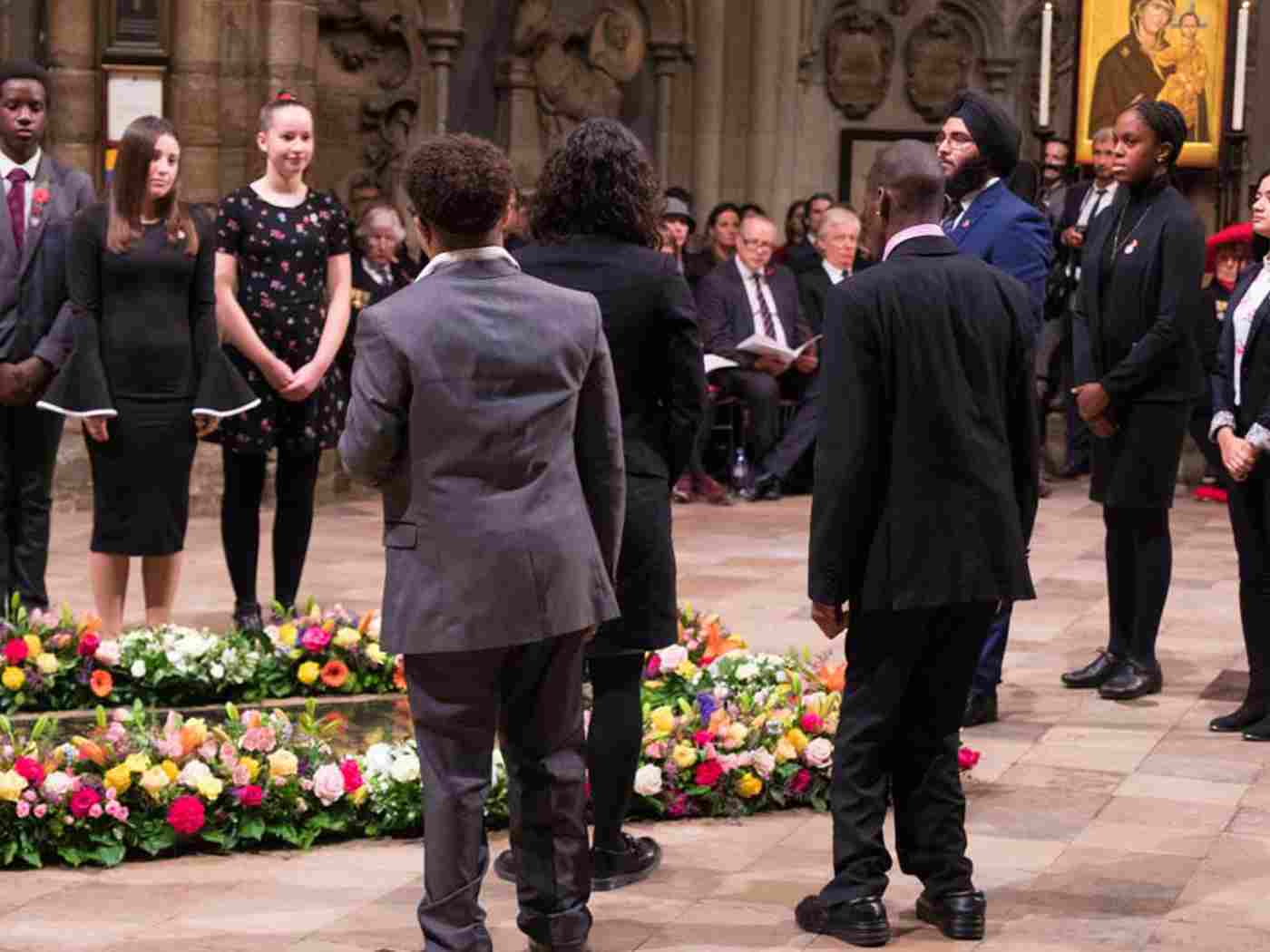 Nine young people place fresh flowers at the Grave of the Unknown Warrior