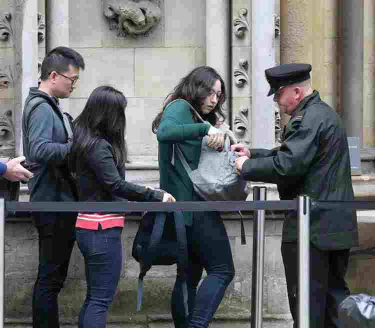 A security Beadle checking bags