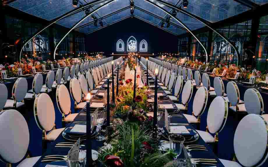A banqueting table set up in a temporary outdoor structure in College Garden
