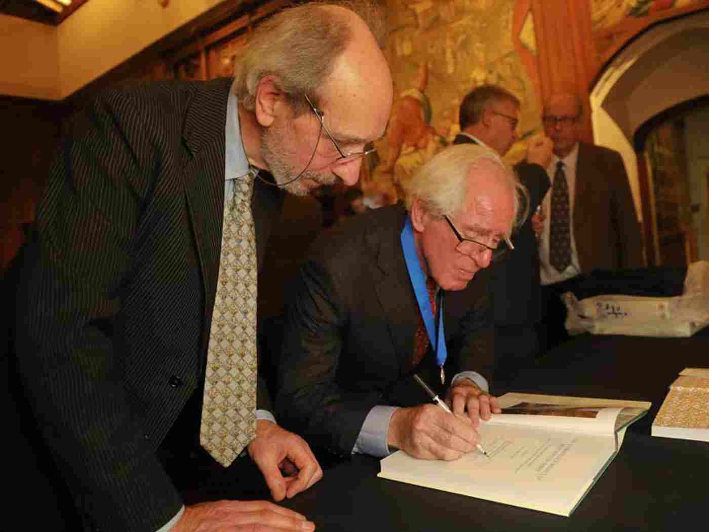 Warwick Rodwell and David S Neal sign copies of their book at the launch