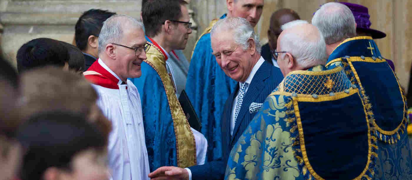James O'Donnell smiling along with King Charles outside Westminster Abbey