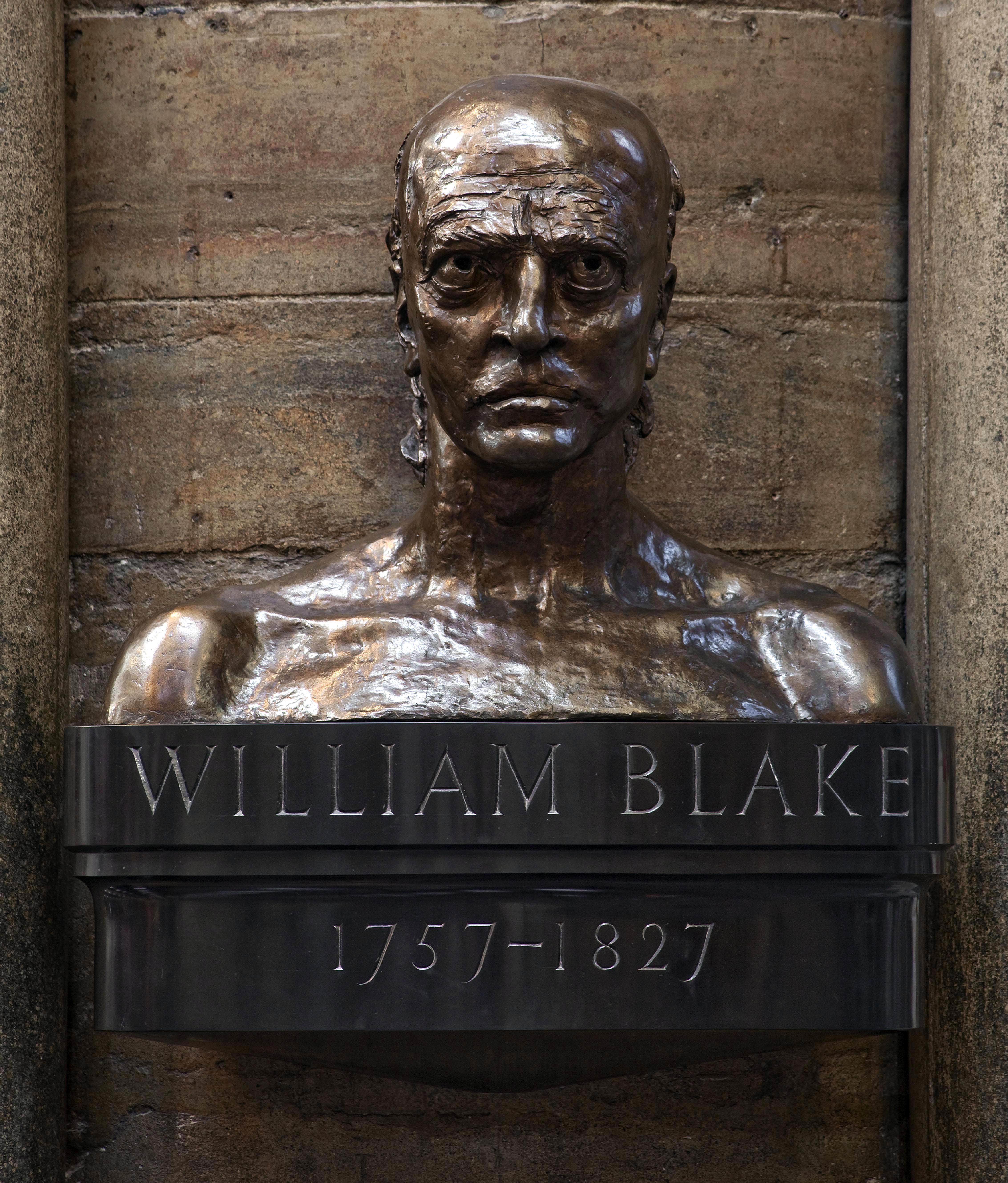 Bronze bust of William Blake atop a black base into which is carved 'William Blake 1757-1827'