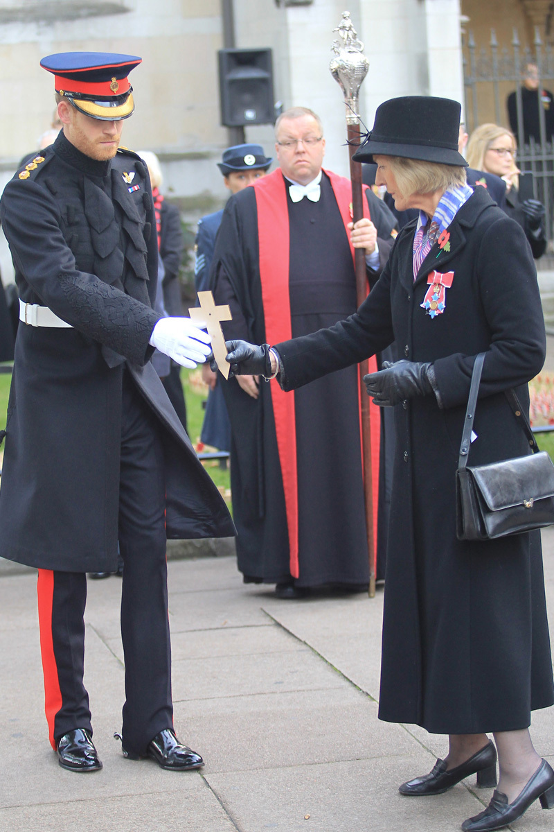 Prince Harry is invited to lay a memorial cross by Mrs Sarah Jones, President of the Royal British Legion Poppy Factory