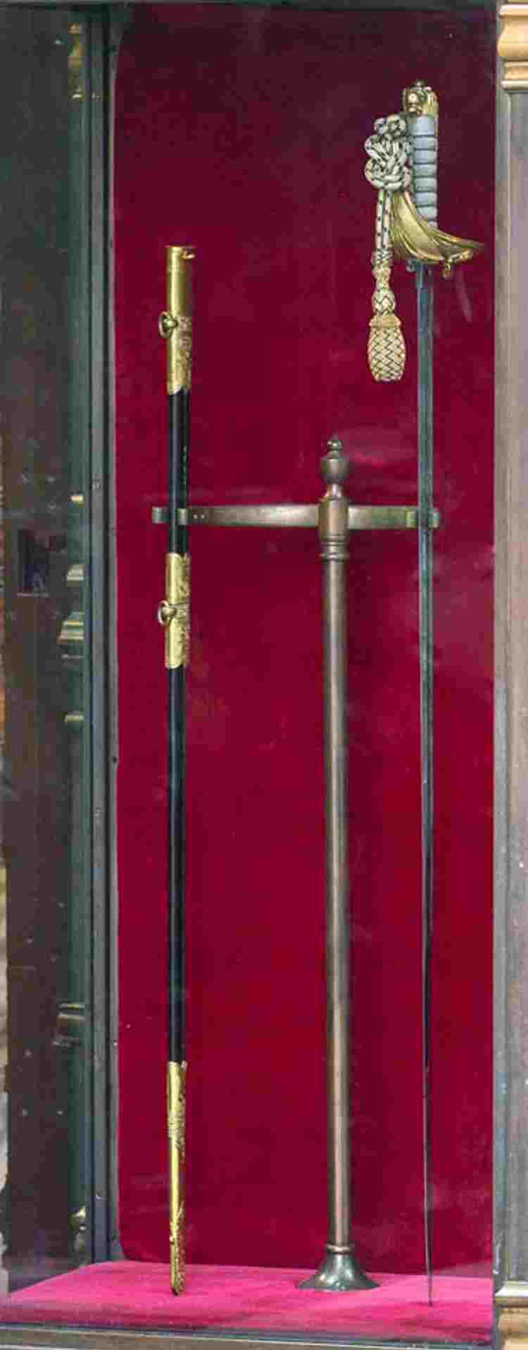 Ceremonial sword and scabbard owned by George VI in a red velvet-lined glass case