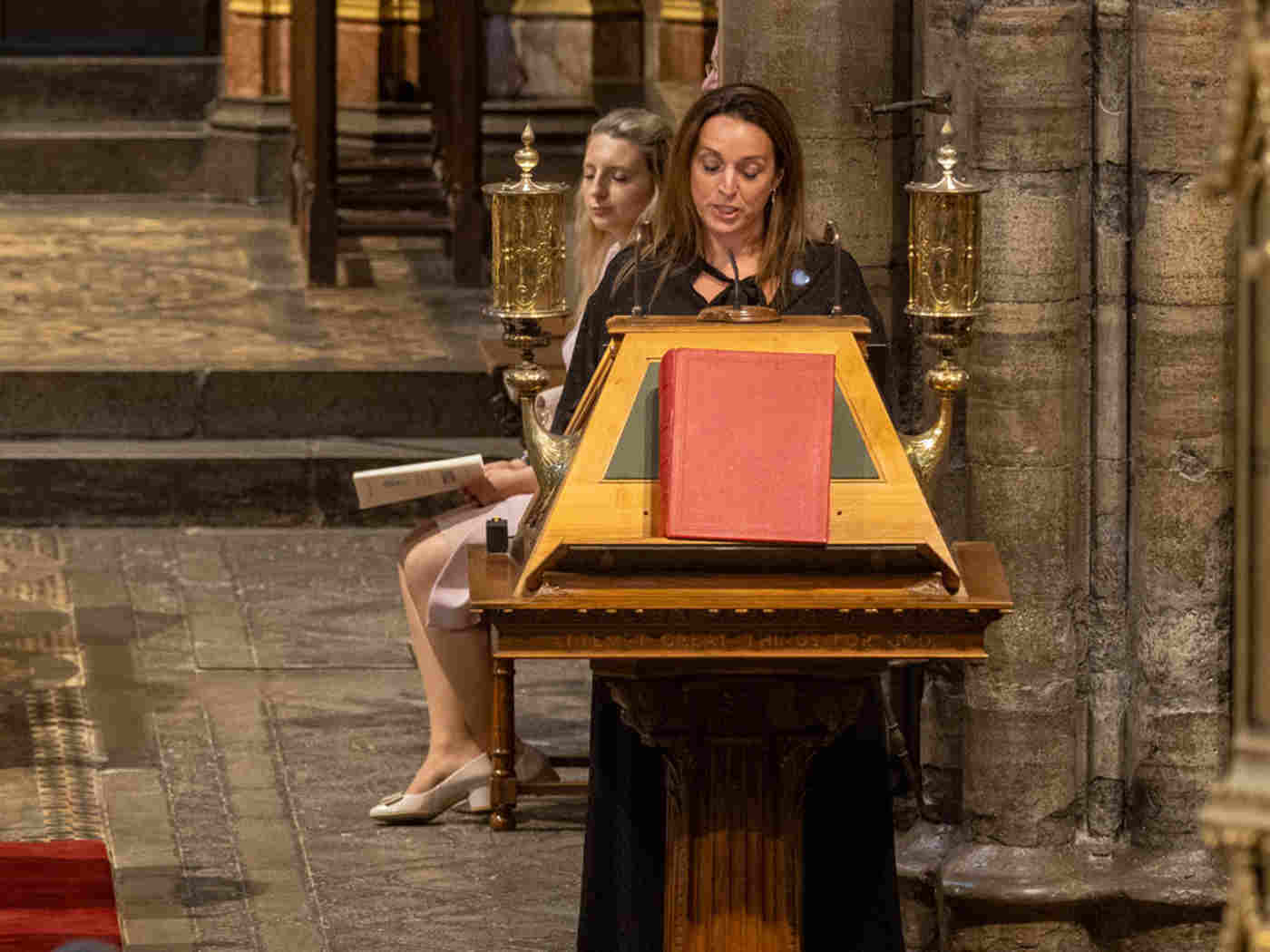 Ellie Orton giving a testimony at a lectern