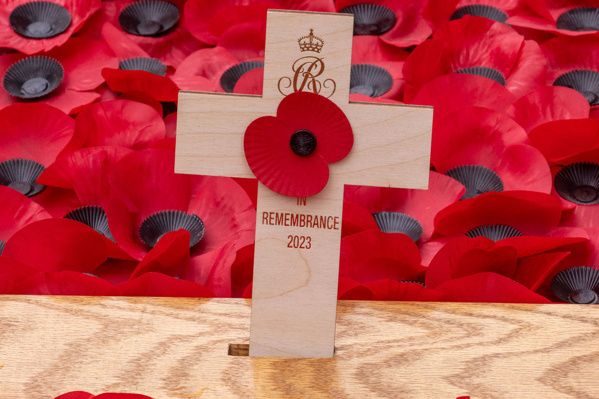 A poppy placed in a cross with 'Remembrance 2023' written underneath