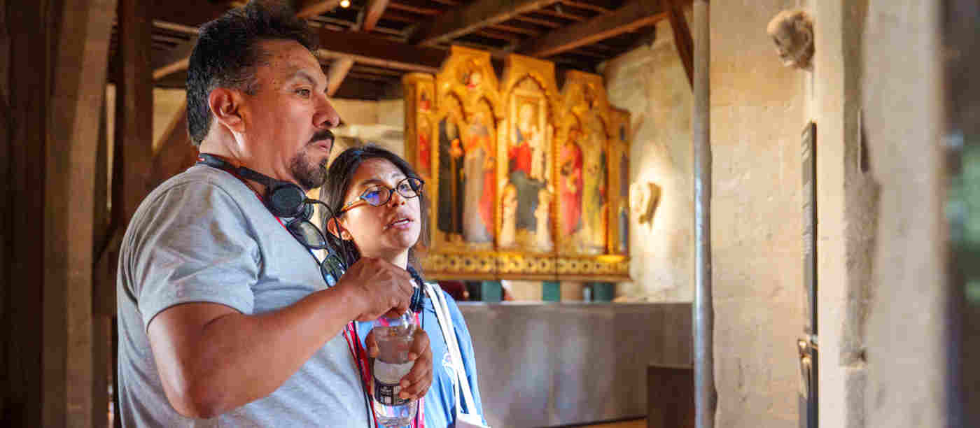 Photograph of two people looking at objects in the Queen's Diamond Jubilee Galleries at Westminster Abbey